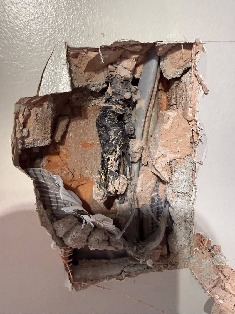 Burnt cable inside a wall